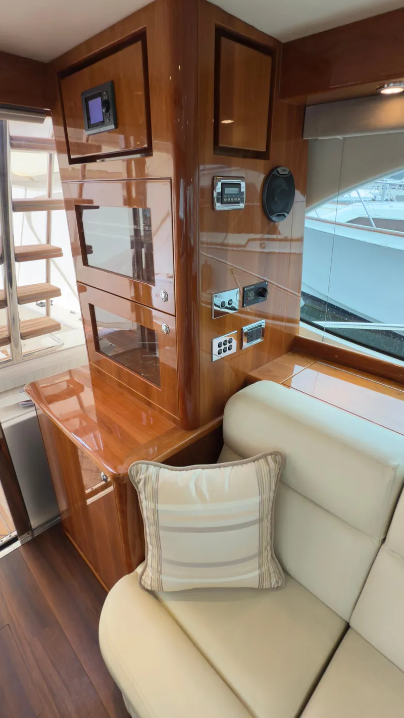 Slide: The Image of Luxurious interior of 2011 Riviera 43 IPS Open Flybridge with polished wood and plush seating. - 8