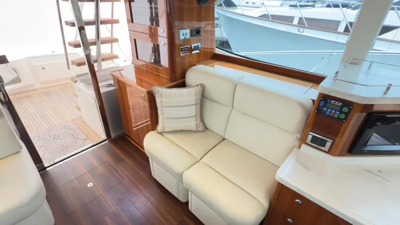 Slide: The Image of Interior of 2011 Riviera 43 IPS Open Flybridge with cream seating and wooden accents. - 9