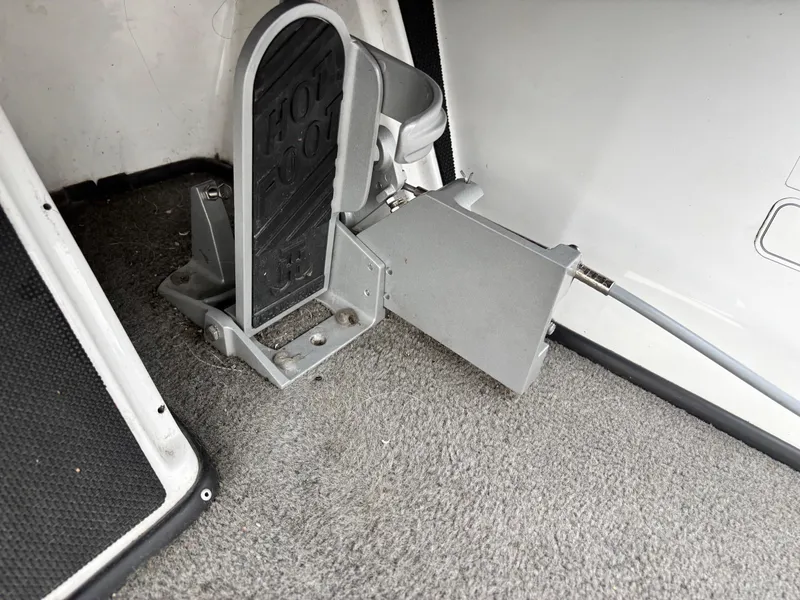 Slide: The Image of Foot pedal mechanism in a 2017 Nitro Z18 boat, on carpeted flooring. - 10