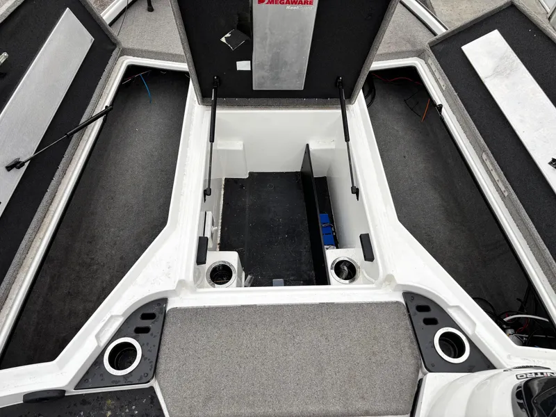 Slide: The Image of 2017 Nitro Z18 boat interior with open storage compartments and carpeted flooring. - 6