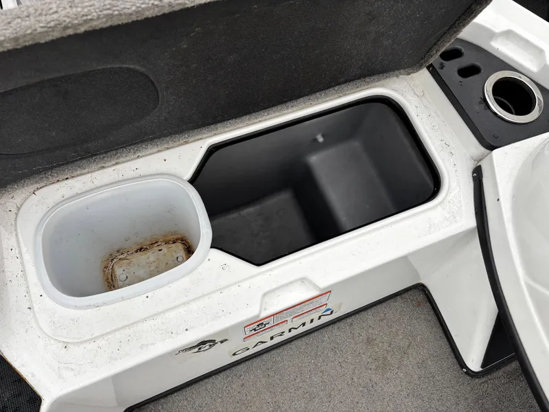 Slide: The Image of Open storage compartment in a 2017 Nitro Z18 boat, featuring a Garmin label. - 7