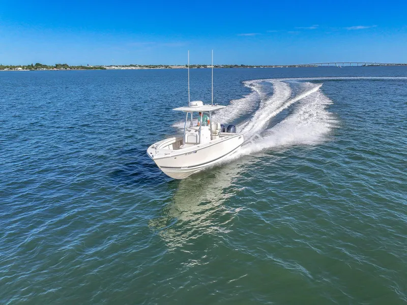 Slide: The Image of 2018 Jupiter 26 FS boat cruising on open water under clear blue sky. - 15
