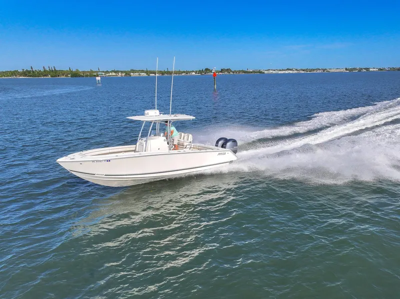 Slide: The Image of 2018 Jupiter 26 FS boat cruising on open water under clear blue sky. - 16