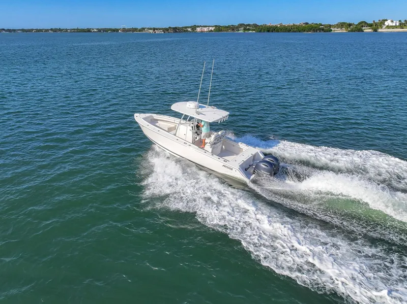 Slide: The Image of 2018 Jupiter 26 FS boat cruising on open water, creating a wake. - 17
