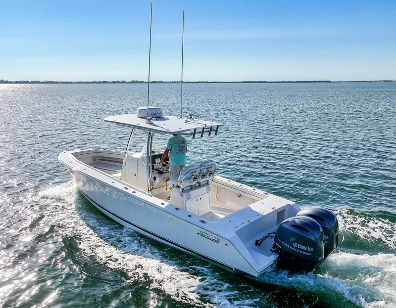 Slide: The Image of 2018 Jupiter 26 FS boat cruising on open water with Yamaha engines. - 2