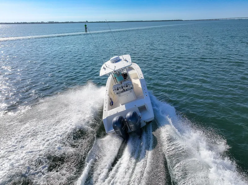Slide: The Image of 2018 Jupiter 26 FS boat cruising on open water, creating a dynamic wake. - 20