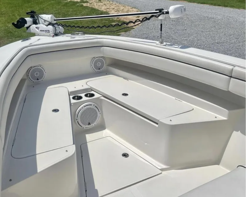 Slide: The Image of 2018 Jupiter 26 FS boat interior with seating, speakers, and storage compartments. - 22