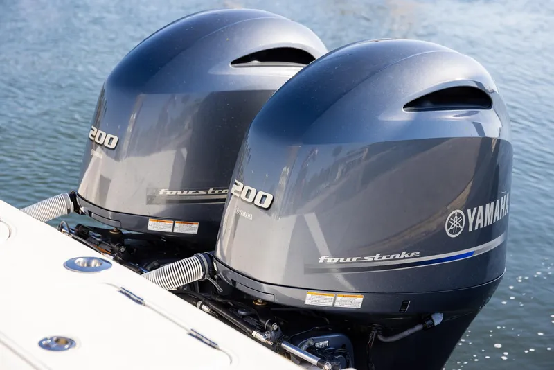 Slide: The Image of Twin Yamaha 200 four-stroke outboard engines on a 2018 Jupiter 26 FS boat. - 25