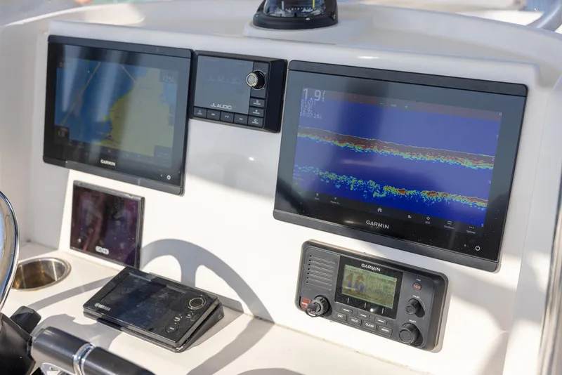 Slide: The Image of Control panel of 2018 Jupiter 26 FS boat with Garmin navigation displays. - 29