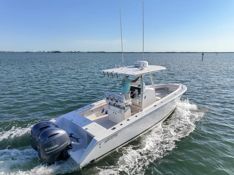 Slide: The Image of 2018 Jupiter 26 FS boat cruising on open water with dual Yamaha engines. - 3