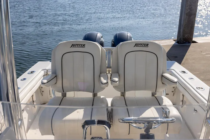Slide: The Image of 2018 Jupiter 26 FS boat with dual seats, docked by the water. - 33