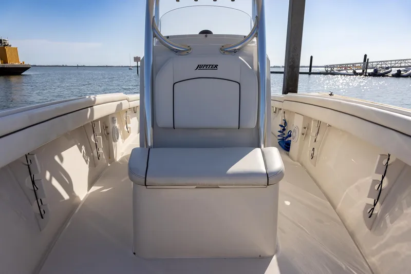 Slide: The Image of 2018 Jupiter 26 FS boat interior with seating, docked by the water. - 34