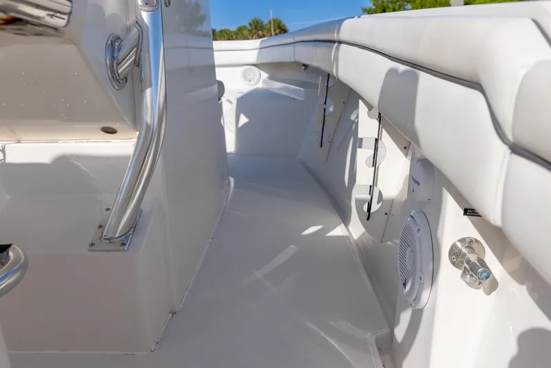 Slide: The Image of Interior view of a 2018 Jupiter 26 FS boat, featuring sleek white seating and stainless steel fixtures. - 36