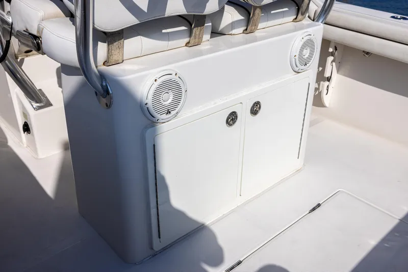 Slide: The Image of 2018 Jupiter 26 FS boat interior with white seating and built-in speakers. - 38