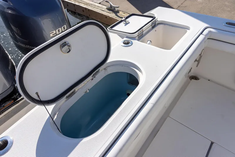Slide: The Image of Open livewell on 2018 Jupiter 26 FS boat with dual 200 horsepower engines. - 39