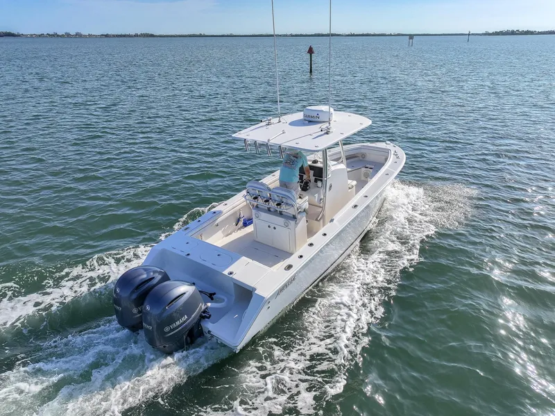 Slide: The Image of 2018 Jupiter 26 FS boat cruising on open water with twin engines. - 4