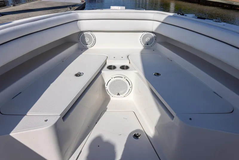 Slide: The Image of Bow seating area of 2018 Jupiter 26 FS boat with speakers and cup holders. - 40