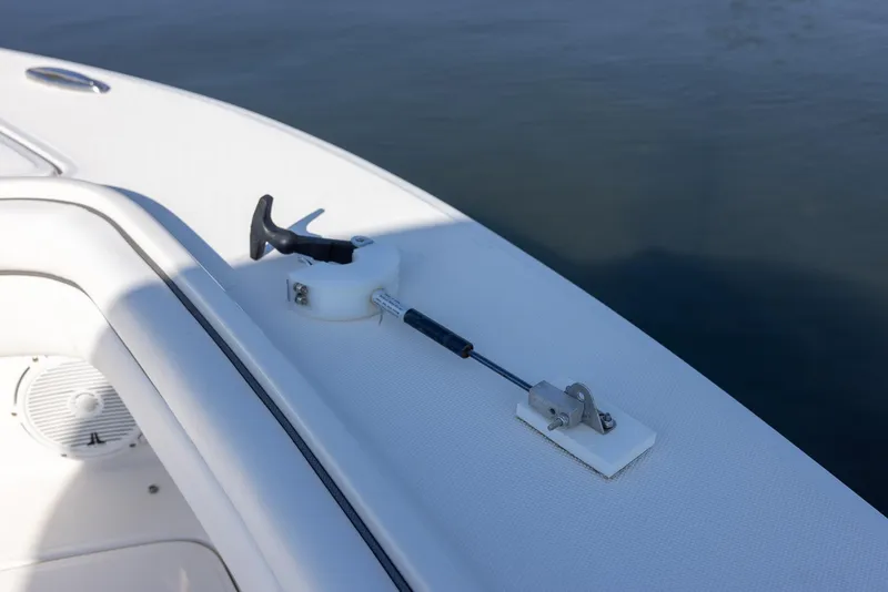 Slide: The Image of 2018 Jupiter 26 FS boat deck with cleat and hardware, on calm water. - 42