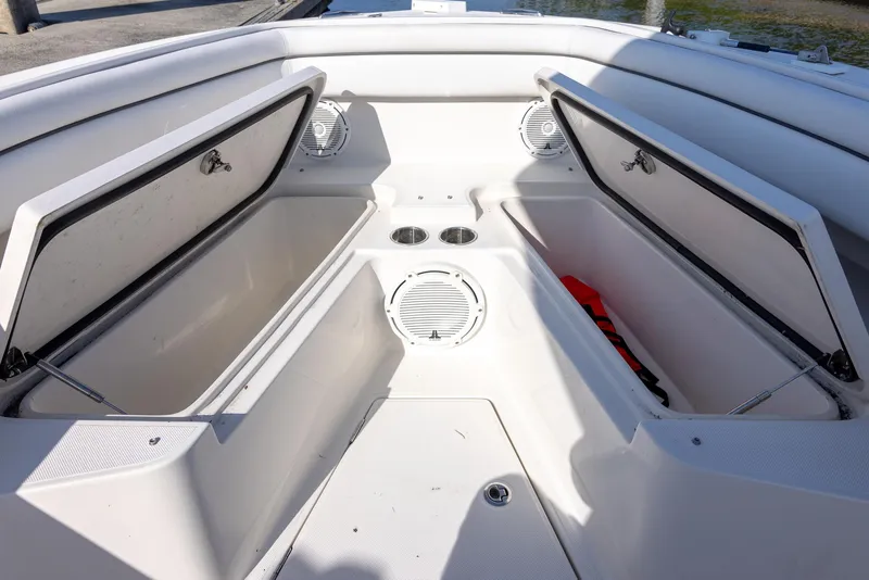 Slide: The Image of 2018 Jupiter 26 FS boat interior with open storage compartments and cup holders. - 43