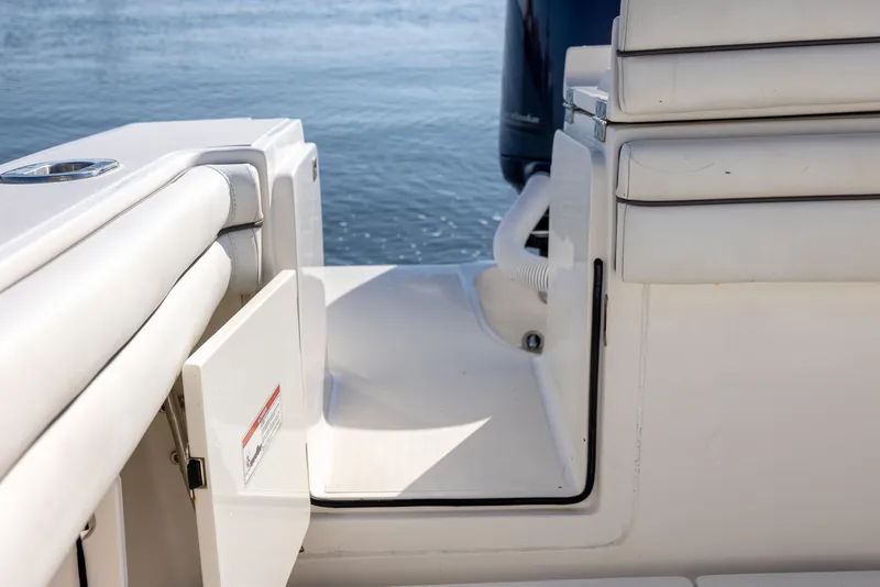 Slide: The Image of 2018 Jupiter 26 FS boat interior with open hatch, white seating, and water view. - 47