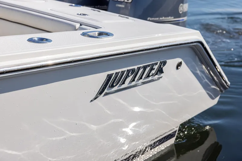 Slide: The Image of 2018 Jupiter 26 FS boat, close-up of logo on sleek white hull. - 49