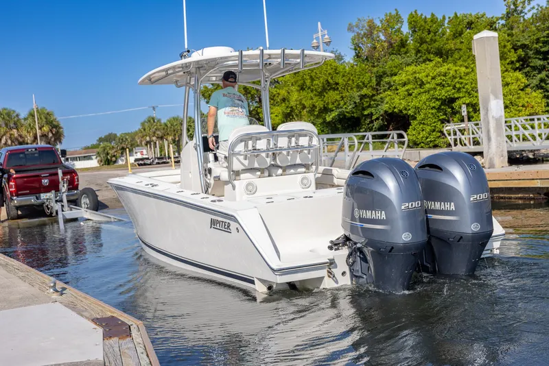 Slide: The Image of 2018 Jupiter 26 FS boat with dual Yamaha engines launching from a dock. - 50