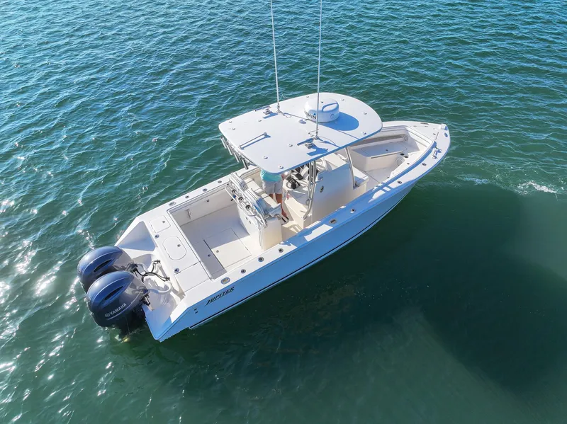 Slide: The Image of 2018 Jupiter 26 FS boat on water, aerial view, twin engines, white hull. - 8