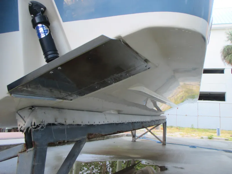 Slide: The Image of 2018 Grady-White Freedom 307 boat hull on trailer, showcasing trim tab and support structure. - 10