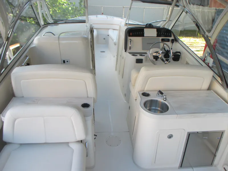 Slide: The Image of 2018 Grady-White Freedom 307 boat interior with seating, steering wheel, and sink. - 13