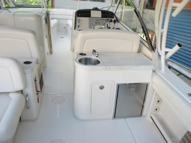 Slide: The Image of 2018 Grady-White Freedom 307 boat interior with sink and seating area. - 14