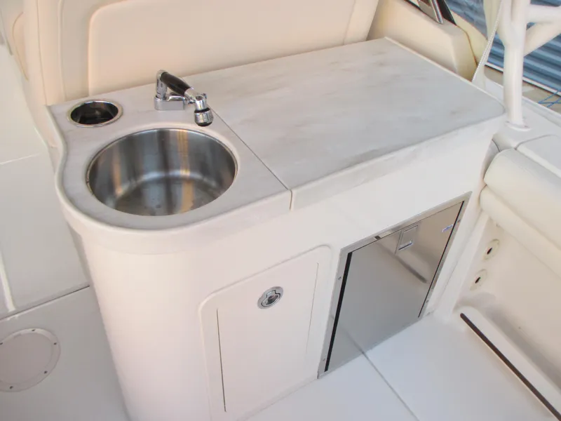 Slide: The Image of 2018 Grady-White Freedom 307 boat sink and countertop area with storage. - 15