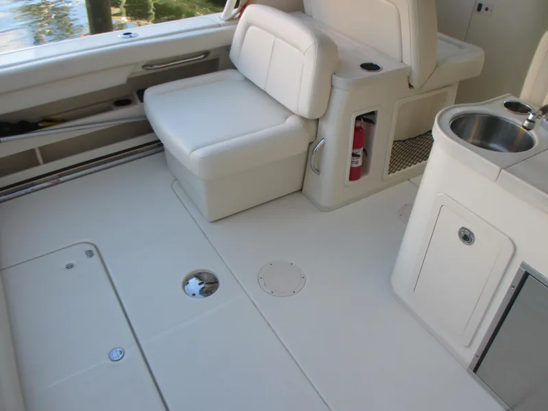 Slide: The Image of 2018 Grady-White Freedom 307 boat interior with seating and sink. - 16