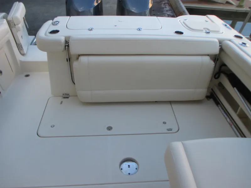 Slide: The Image of 2018 Grady-White Freedom 307 boat interior with cushioned seating and storage compartments. - 19