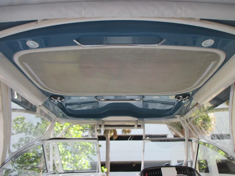 Slide: The Image of 2018 Grady-White Freedom 307 boat interior, featuring a sleek blue ceiling design. - 21