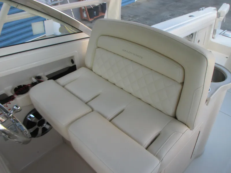 Slide: The Image of Luxurious seating on 2018 Grady-White Freedom 307 boat, featuring cream upholstery and elegant design. - 26