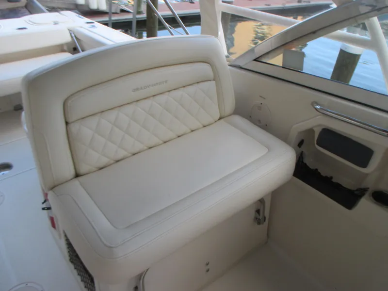 Slide: The Image of 2018 Grady-White Freedom 307 boat seat with quilted upholstery, dockside view. - 28