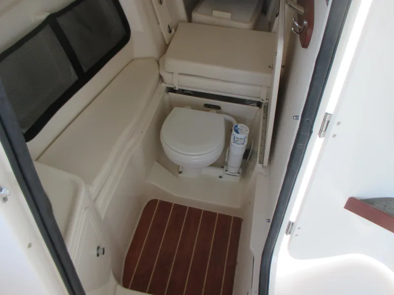 Slide: The Image of 2018 Grady-White Freedom 307 boat interior with compact marine toilet. - 29