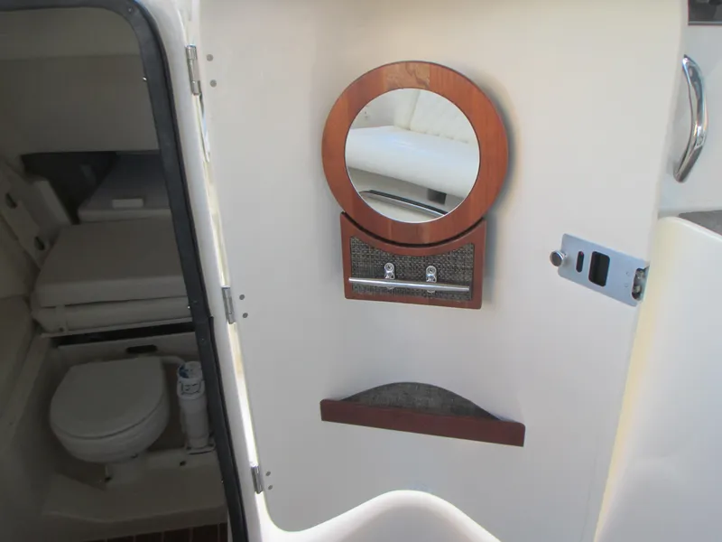 Slide: The Image of 2018 Grady-White Freedom 307 boat interior with bathroom and mirror. - 30