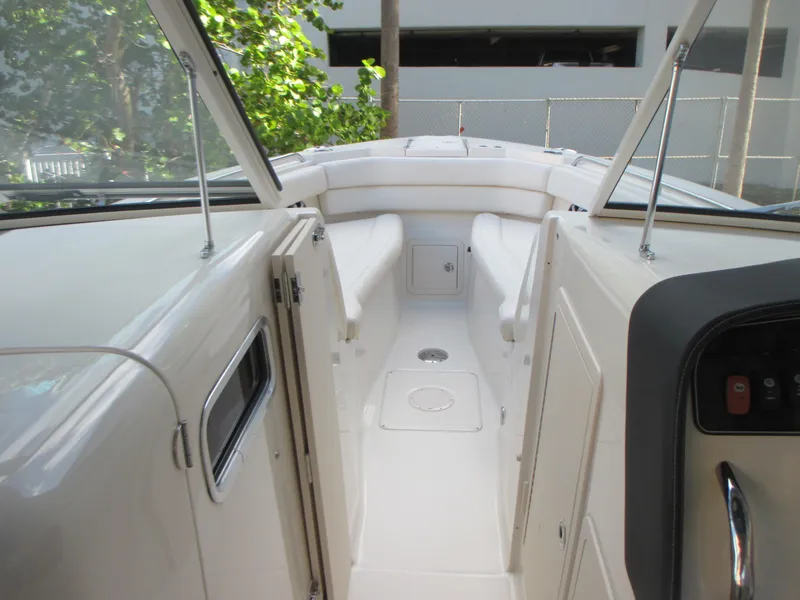 Slide: The Image of 2018 Grady-White Freedom 307 boat interior with white seating and sleek design. - 32