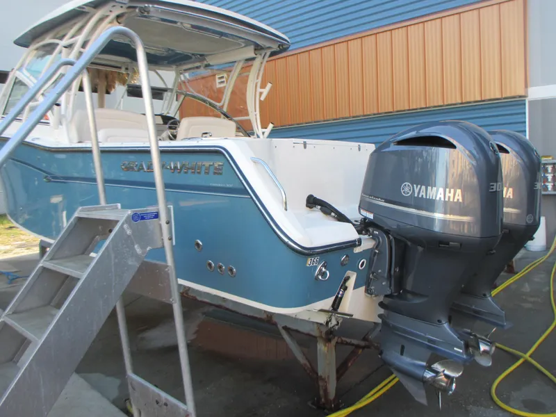 Slide: The Image of 2018 Grady-White Freedom 307 boat with dual Yamaha engines, docked and ready for adventure. - 5
