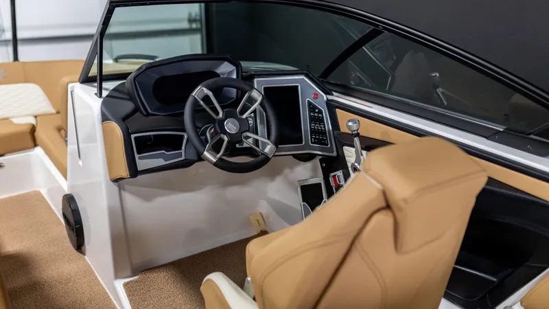Slide: The Image of 2024 MasterCraft X24 boat interior with modern steering and tan seating. - 2