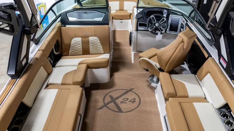 Slide: The Image of 2024 MasterCraft X24 boat interior with luxurious tan and white seating, modern dashboard. - 3