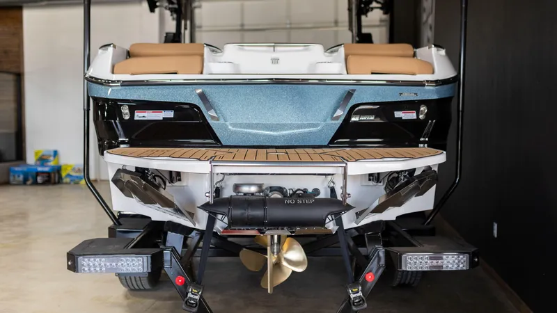 Slide: The Image of 2024 MasterCraft X24 boat rear view with teak swim platform and propeller. - 5