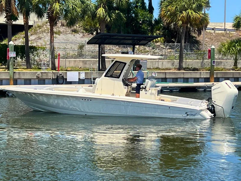 The Image of 2025 Scout 281 XSS boat cruising on a sunny day near palm trees. - 0