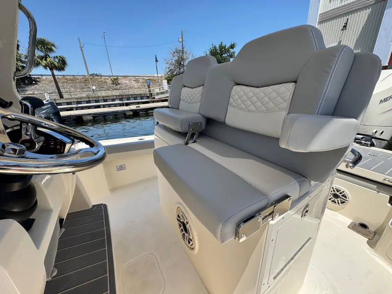 Slide: The Image of 2025 Scout 281 XSS boat interior with gray seating and steering wheel. - 10