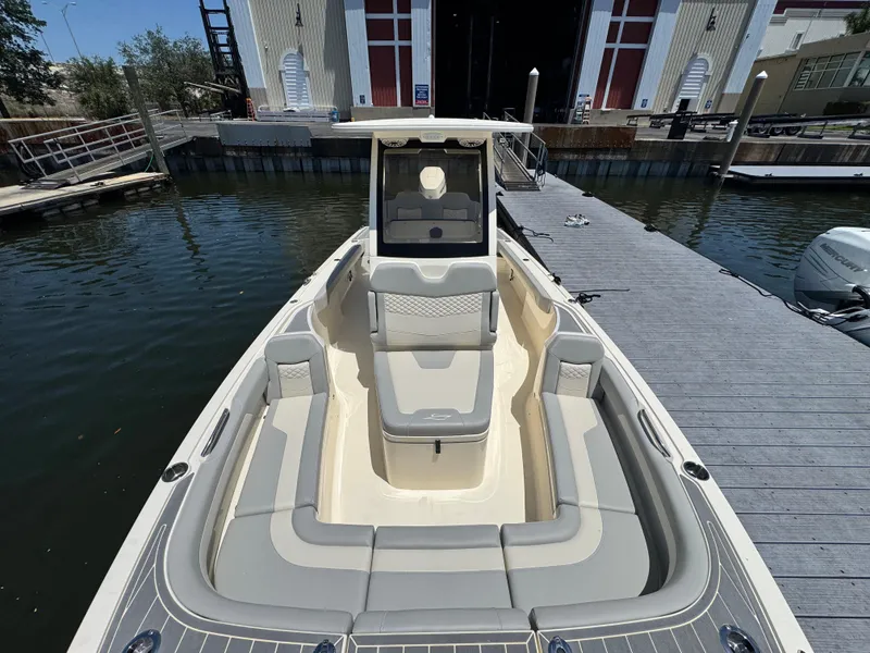 Slide: The Image of 2025 Scout 281 XSS boat docked, showcasing spacious seating and sleek design. - 17