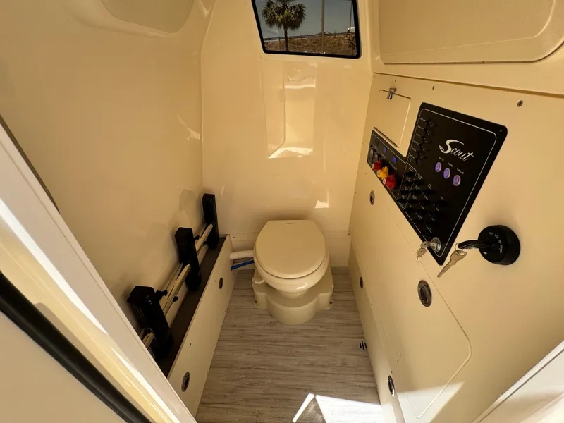 Slide: The Image of 2025 Scout 281 XSS boat interior with toilet and control panel. - 20