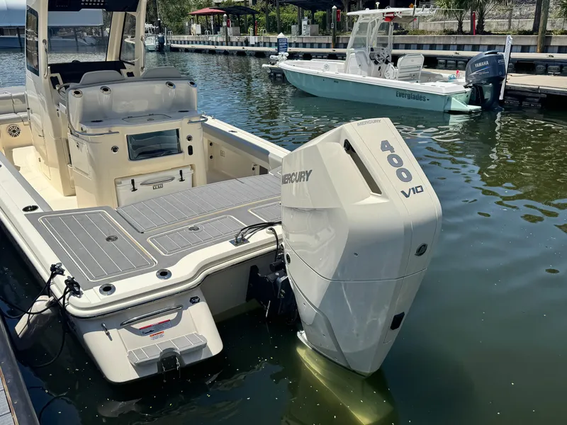 Slide: The Image of 2025 Scout 281 XSS boat with Mercury 400 V10 engine docked in marina. - 21
