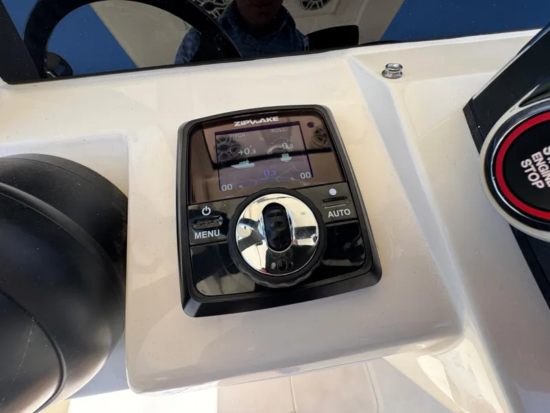 Slide: The Image of Control panel of a 2025 Scout 281 XSS boat with digital display and buttons. - 23