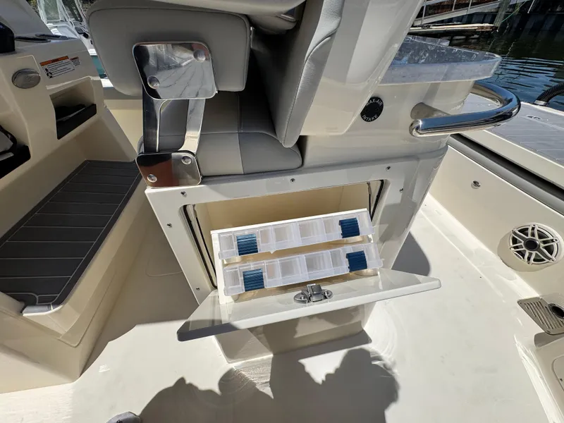 Slide: The Image of 2025 Scout 281 XSS boat interior with open storage compartment and seating. - 25